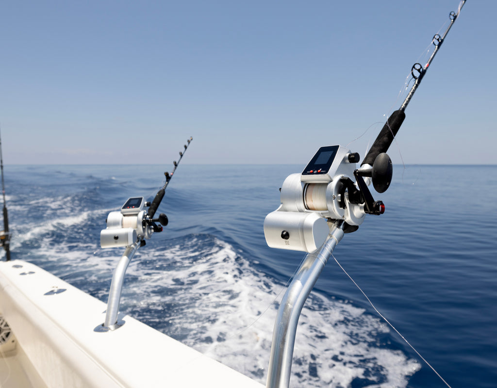 Fishing rods on a boat with a clear blue sky and ocean background