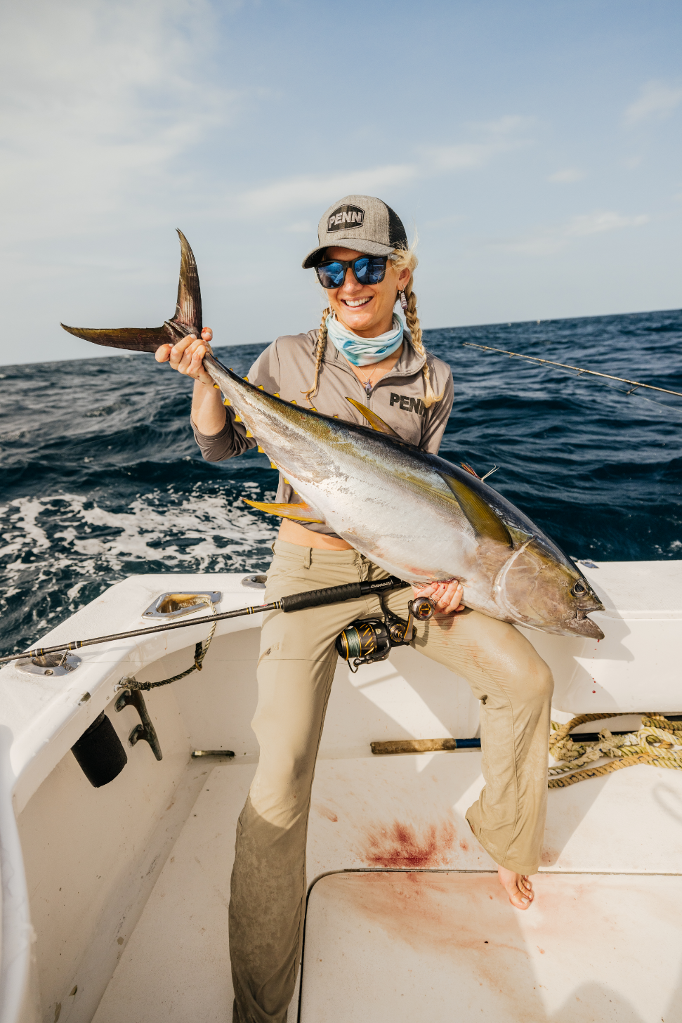 Woman smiling holding a large fish