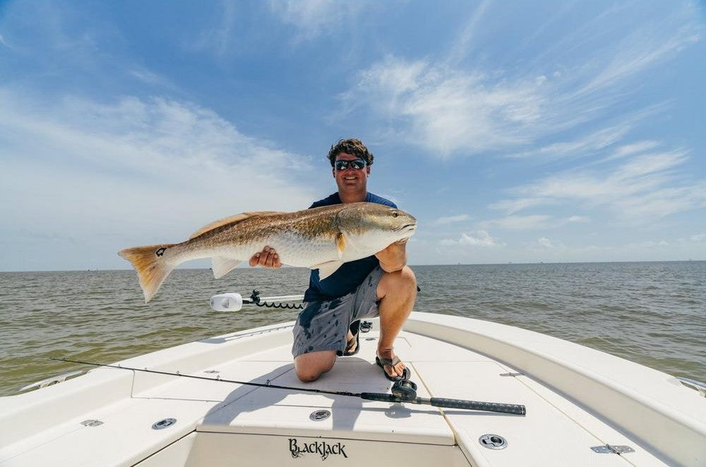Man holding fish caught with Battalion II Inshore Casting Rod