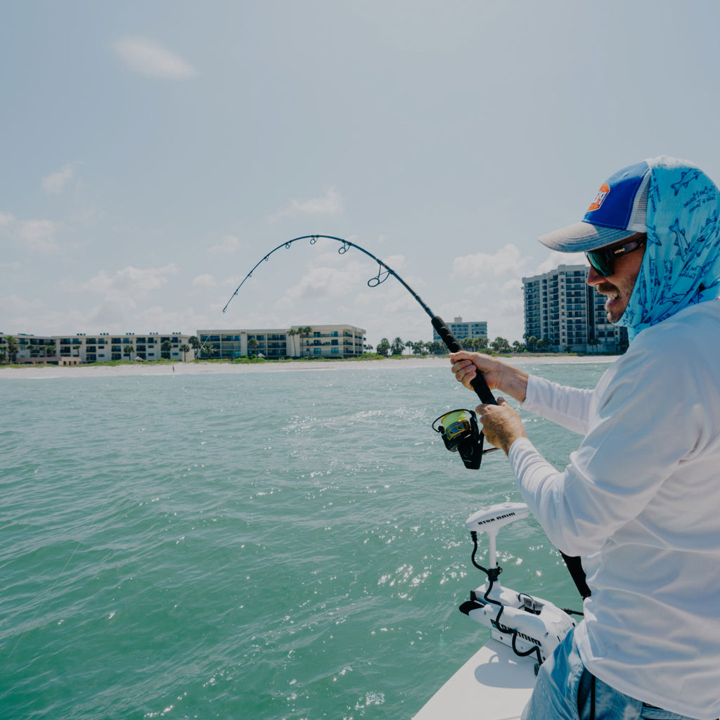Man smiling while fishing inshore