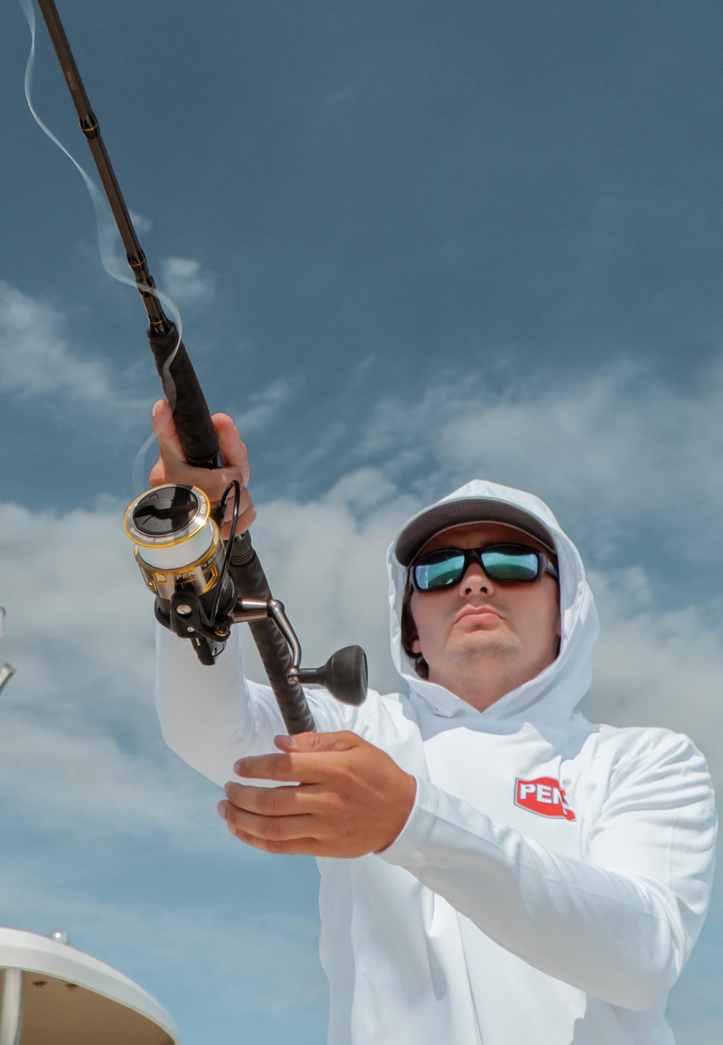 Man fishing wearing PENN apparel