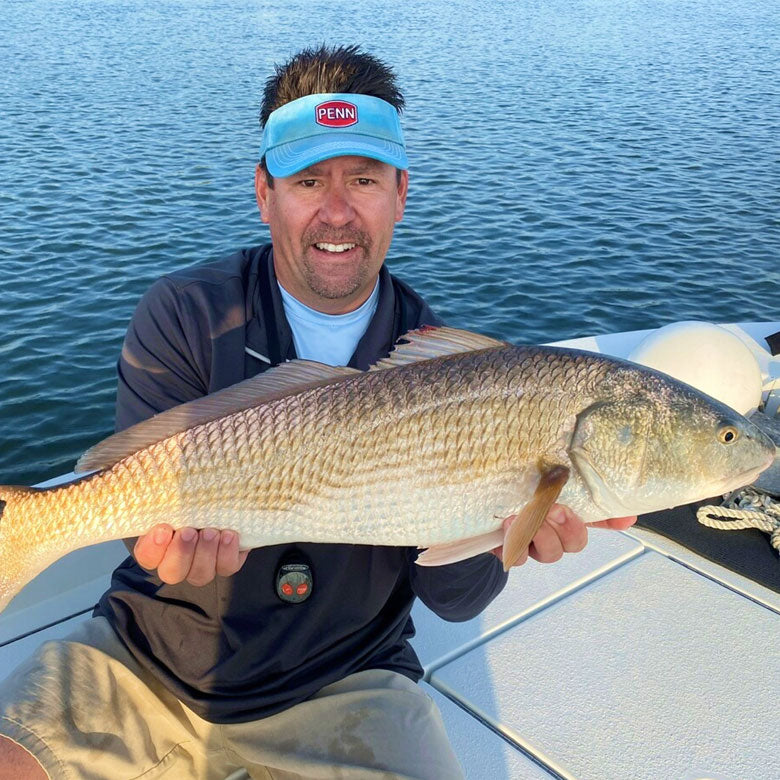 Captain Jot Owens holding a large fish