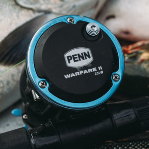 Fishing reel with 'PENN Warfare II' branding on a blurred background