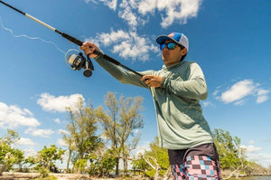 Man fishing with Pursuit IV Spinning Combo