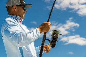 Man fishing with Slammer IV Spinning Reel