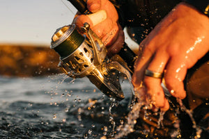 Close-up of a fishing reel being used in water